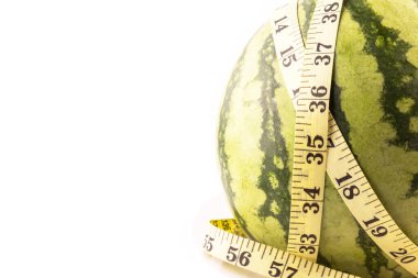 Diyet kavramı. Beyaz arka planda izole edilmiş mezura ile taze yeşil kavun.