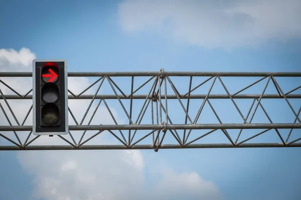 Red color turn left on the traffic light with blue sky background