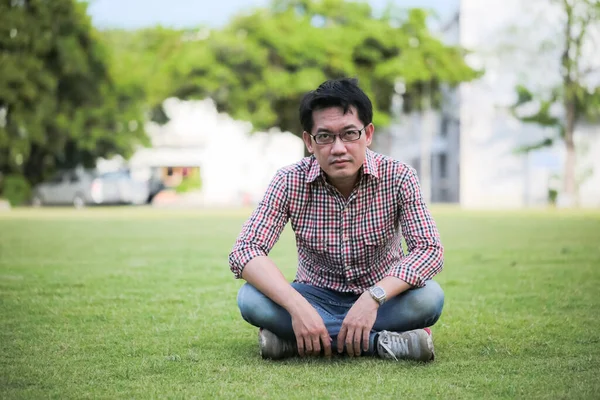 Man Wearing Check Shirt Blue Jeans Sitting Green Lawn Wearing — Stock Photo, Image