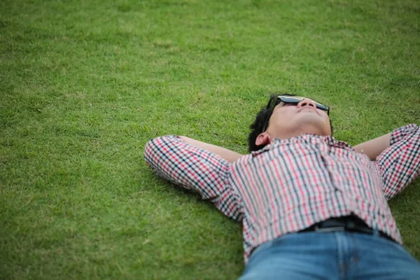 Man Lying Green Grass Wearing Check Shirt Blue Jeans Park Royalty Free Stock Photos