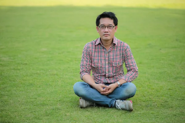 Man Wearing Check Shirt Blue Jeans Sitting Green Lawn Wearing — Stock Photo, Image