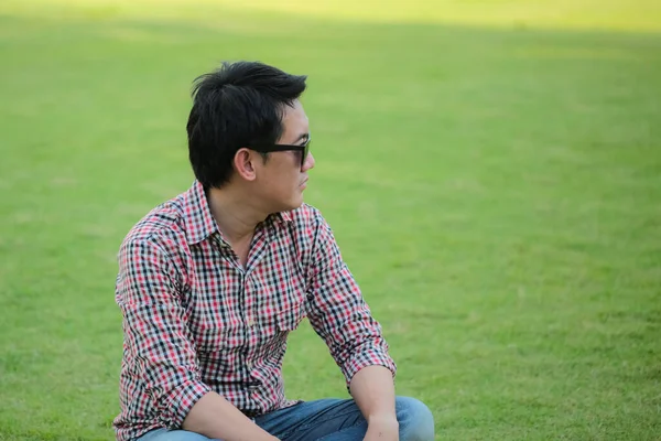 Man Wearing Check Shirt Blue Jeans Sitting Green Lawn Wearing — Stock Photo, Image