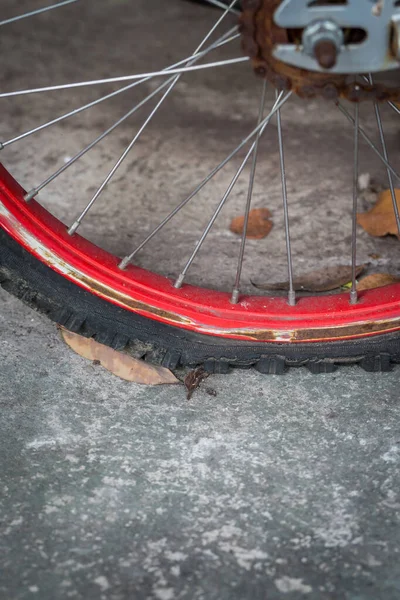 Close up of flat bicycle tire old and rust on cement background