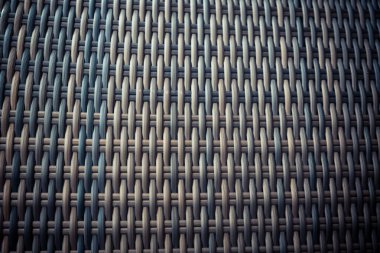 Sentetik rattan dokuma arka planı bahçe mobilyalarında kullanılıyor..