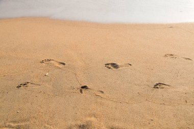 Sahilde baba ve çocuğun ayak izleri var.