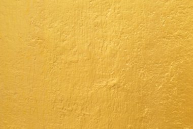 Çimento duvar dokusunda altın boya.