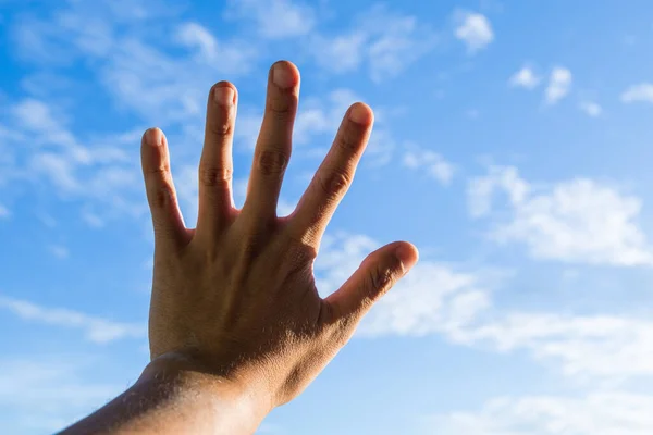 hand in sky holding something background