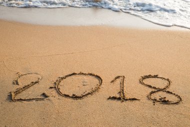 2018 plaj arka planındaki kuma yazılmış bir mesaj.