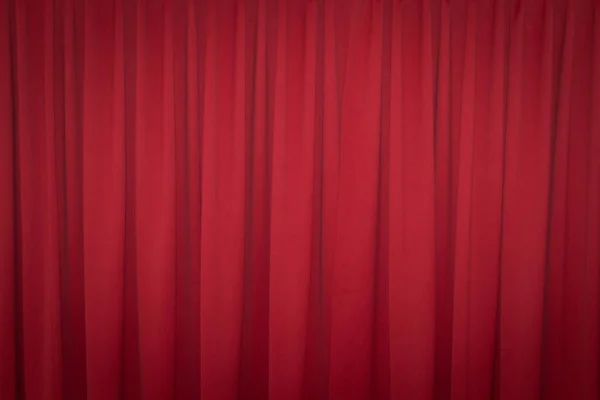 Red closed curtain with a light spot use for background