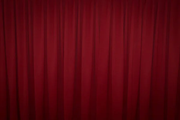 Red closed curtain with a light spot use for background