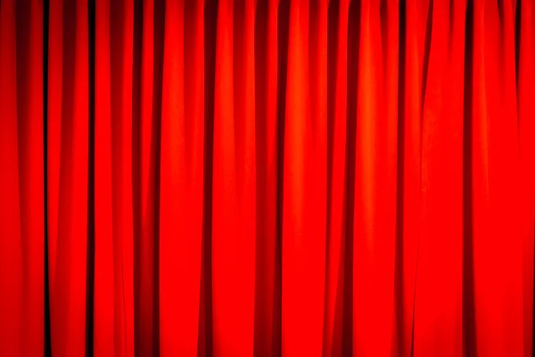 Red closed curtain with a light spot use for background