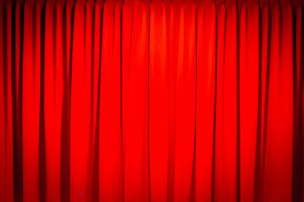 Red closed curtain with a light spot use for background