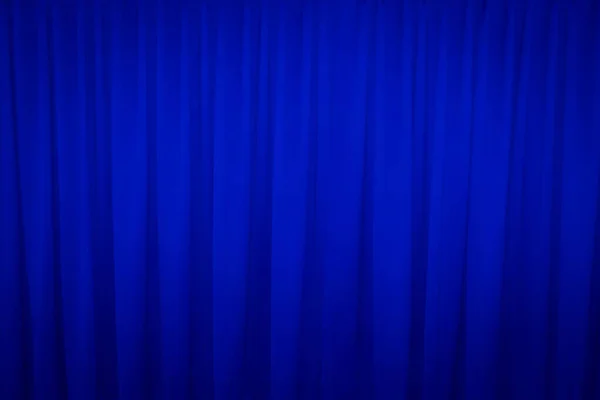 Blue closed curtain with a light spot use for background