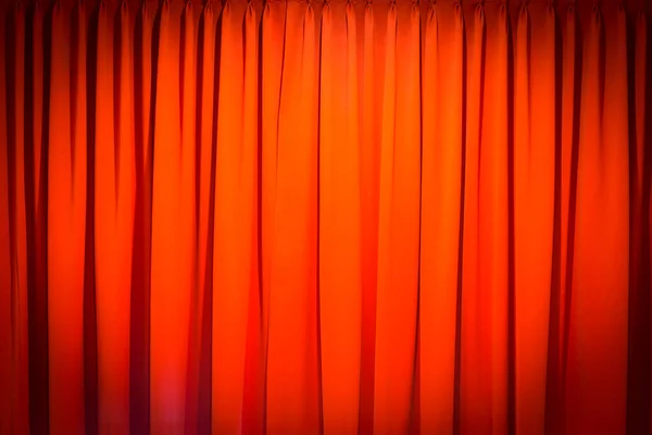 Red closed curtain with a light spot use for background