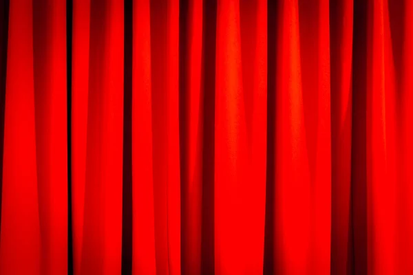 Red closed curtain with a light spot use for background