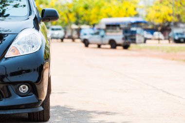 Otoparkın arka planındaki siyah otoparkın yarı önü.