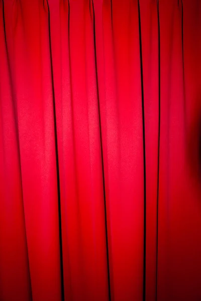 Red closed curtain with a light spot use for background