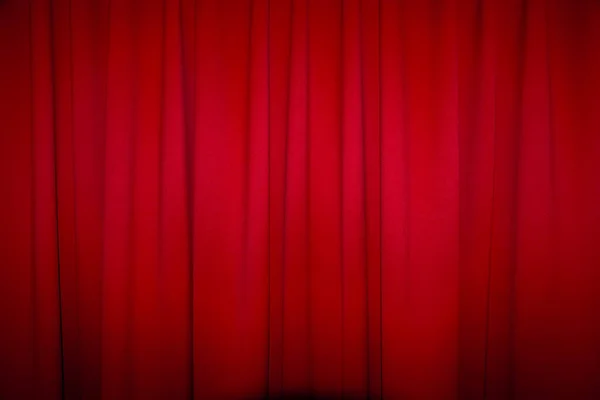 Red closed curtain with a light spot use for background