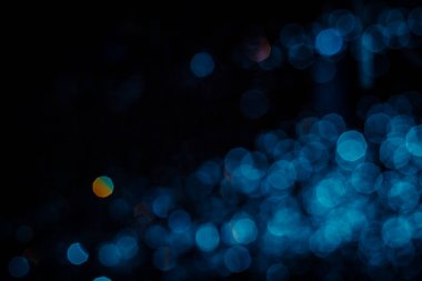 Siyah arkaplanda soyut mavi bokeh dokusu