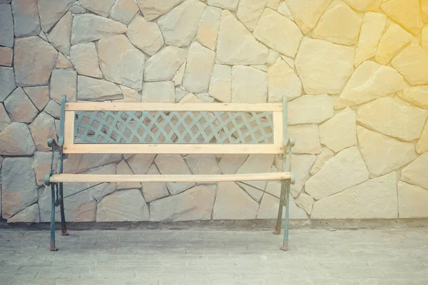 Vintage wooden chair with stone wall background