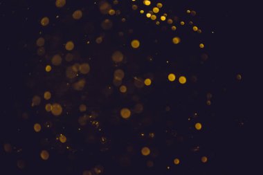 Altın bokeh, siyah arka planlı bulanık lüks