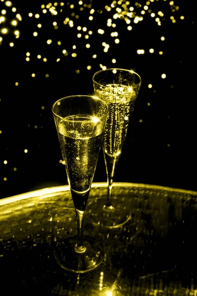 Two glasses of champagne, toned in yellow — Stock Photo, Image