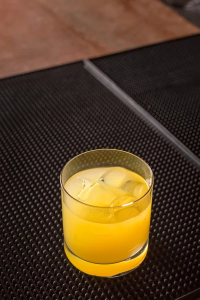 Screw driver cocktail on a bar ribber mat — Stock Photo, Image