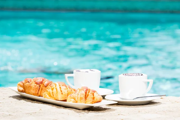 Dos tazas de café con arte latte y croissants — Foto de Stock