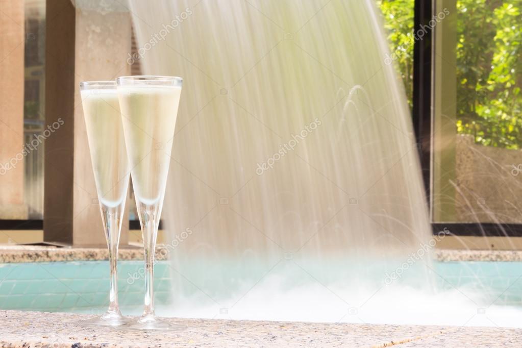 Two glasses of champagne near outdoor jacuzzi