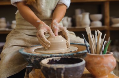 hands of a potter, creating an earthen jar on the circle clipart