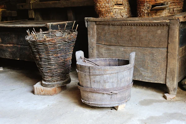 Wooden bucket and wicker basket in the shed — Stock Photo, Image