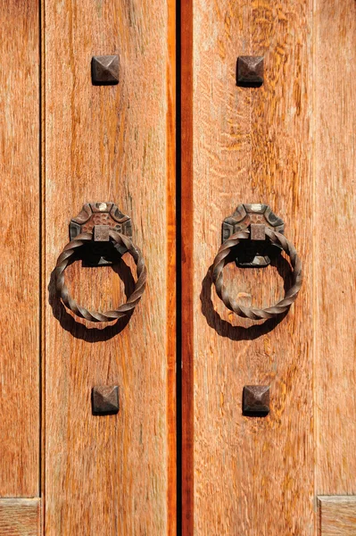 Fragment of wooden door with metal handles — Stock Photo, Image