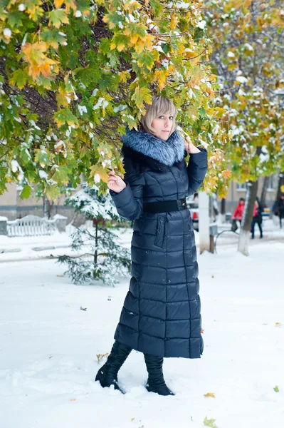 Portret van een meisje op de straat in de winter met sneeuw — Stockfoto