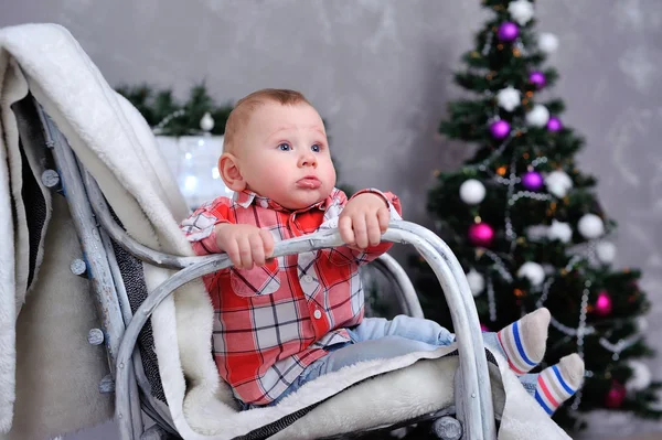 Child near the Christmas tree — Stock Photo, Image