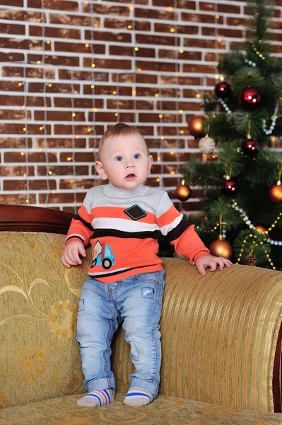 Child near the Christmas tree — Stock Photo, Image