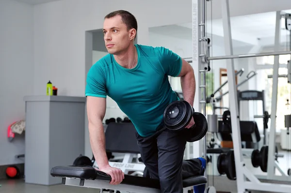 Image of fitness guy in gym exercising with dumbbells — Stock Photo, Image