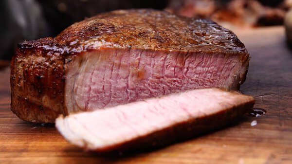Grilled beef steak on a wooden board