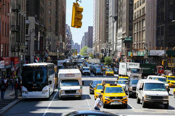 New York City, USA - May 19, 2014: Many cars driving and waiting on the 8th Avenue in midtown manhattan.
