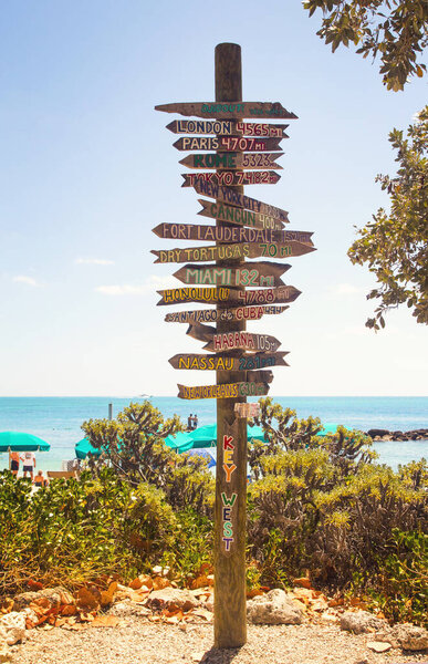 Directional signpost on the southernmost point of USA- Key West, Fort Zachary Taylor Historic State Park tropical sandy beach on dayligh
