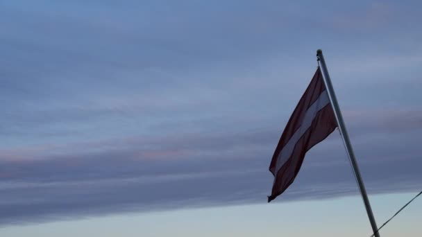 Lettische Flagge auf einer Fähre bei Sonnenuntergang — Stockvideo