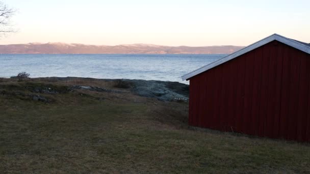 Ειδυλλιακή τοποθεσία κόκκινο ξύλινο σπίτι στο σκανδιναβικό fjord — Αρχείο Βίντεο