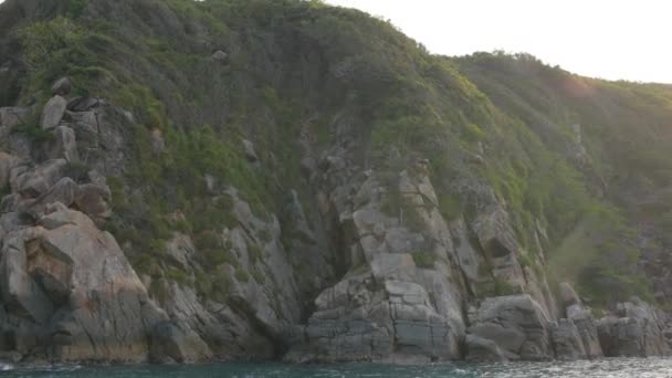 Paisagem rochosa em uma costa do mar que se estende da esquerda para a direita. Vista de barco em movimento — Vídeo de Stock