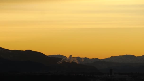 Magic hour sunset lights in northern mountains with smoking pipe, Norway — Stock Video