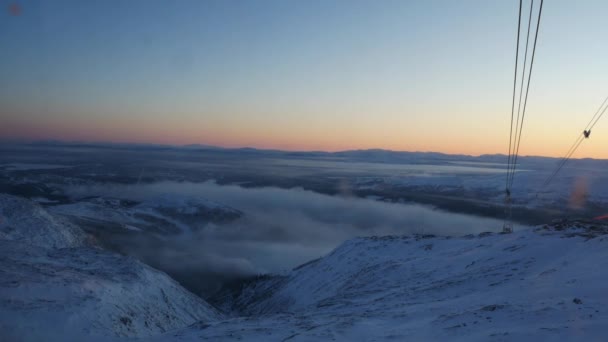 View from moving cabin on oncoming tower of cable car and setting sun. Sweden — Stock Video