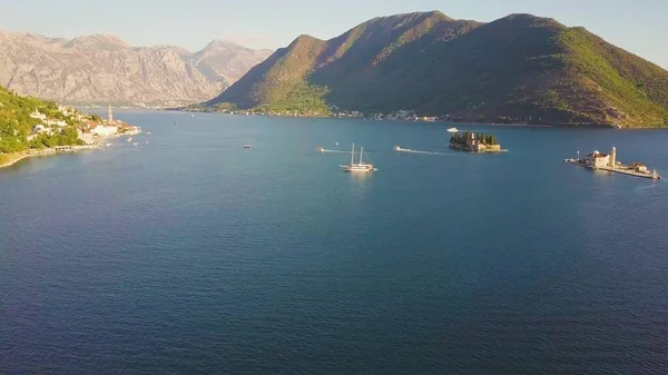 Kotor Körfezi 'nde ortaçağ Kristian kiliseleri olan adalar. Yelkenli gemi ve motorbotlar etrafta yüzüyor.
