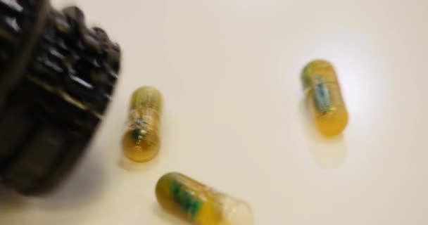 Pills spilling out of bottle — Stock Video