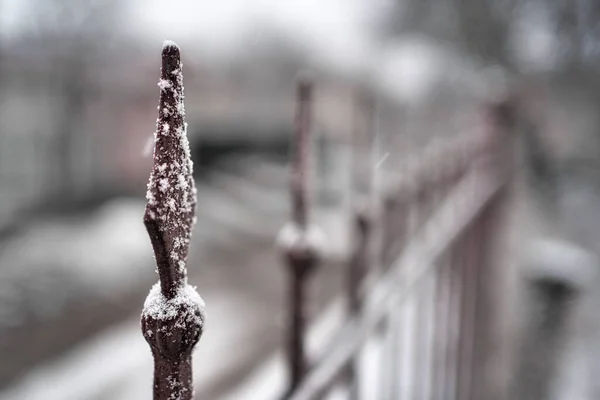 snow on the edge of the fence.Close Up Detail shot.cold winter day.Image with selective focus.weather forecast. Wallpaper. Background.