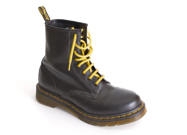 Classic black Dr. Martens lace-up boot with yellow laces — Stock Photo, Image