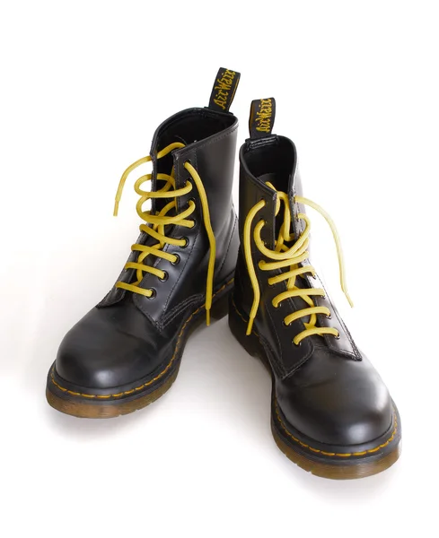 Classic black lace-up boots with yellow laces — Stock Photo, Image