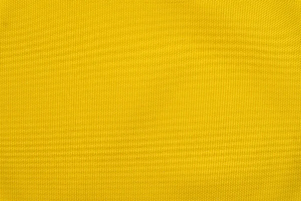 Fondo amarillo brillante hecho de material textil. Tejido con textura natural. Tejido aislado fondo — Foto de Stock